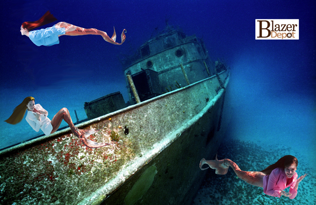 mermaids in blazers next to shipwreck